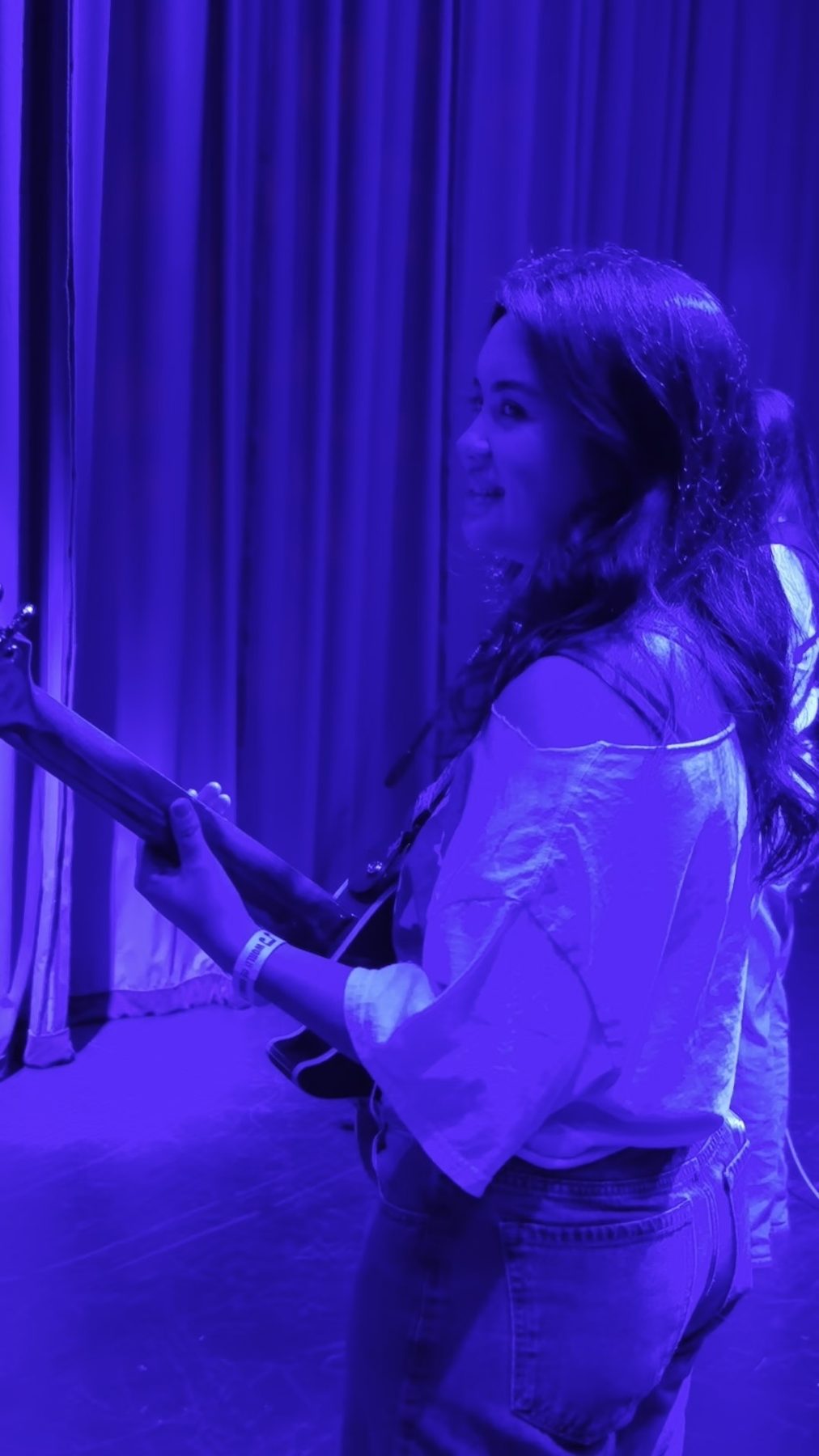 A guitarist under blue light during the Division 1 Final